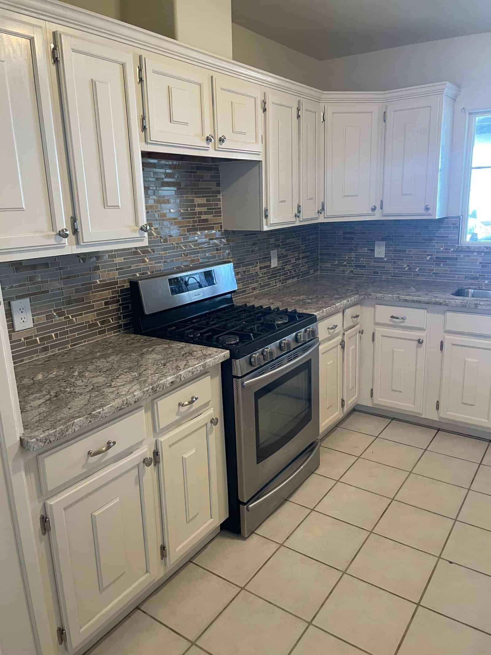 High-quality kitchen cabinets and backsplash designed by COVAGUI Construction Inc. for a stylish and functional home upgrade.